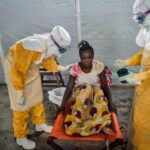 Healthcare workers in protective suits during an Ebola disease response