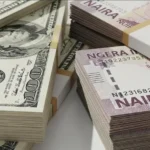 us dollar and nigerian naira notes representing the black market dollar-to-naira exchange rate in nigeria.